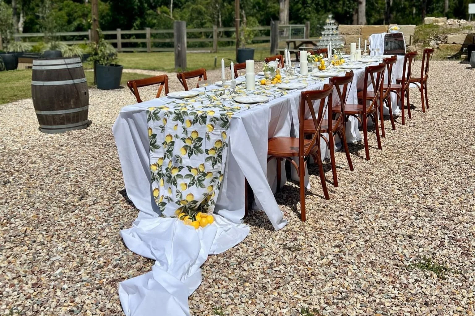 outdoor table setting with draped tablecloths and lemon prints