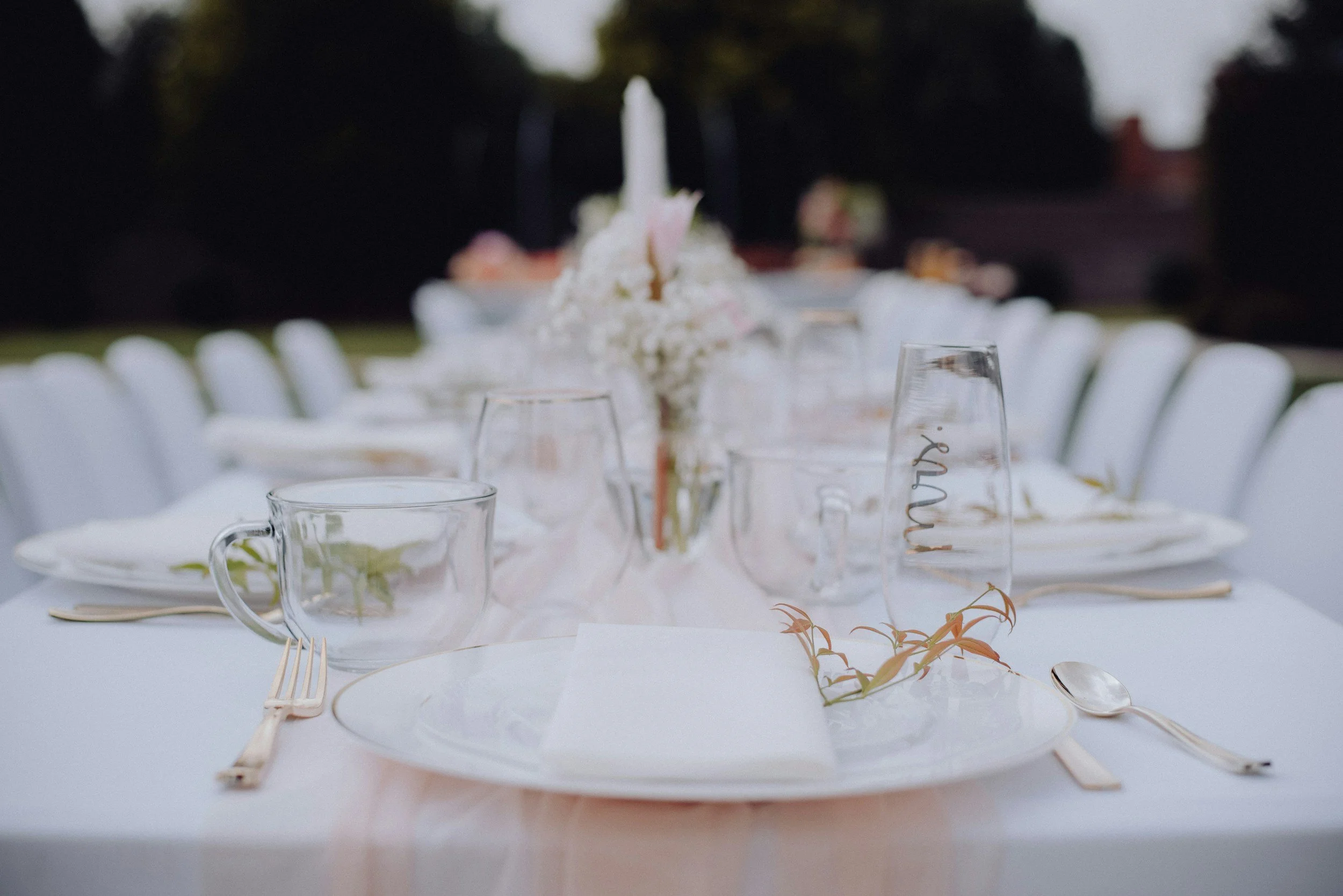 Close up of wedding tablescape in all white