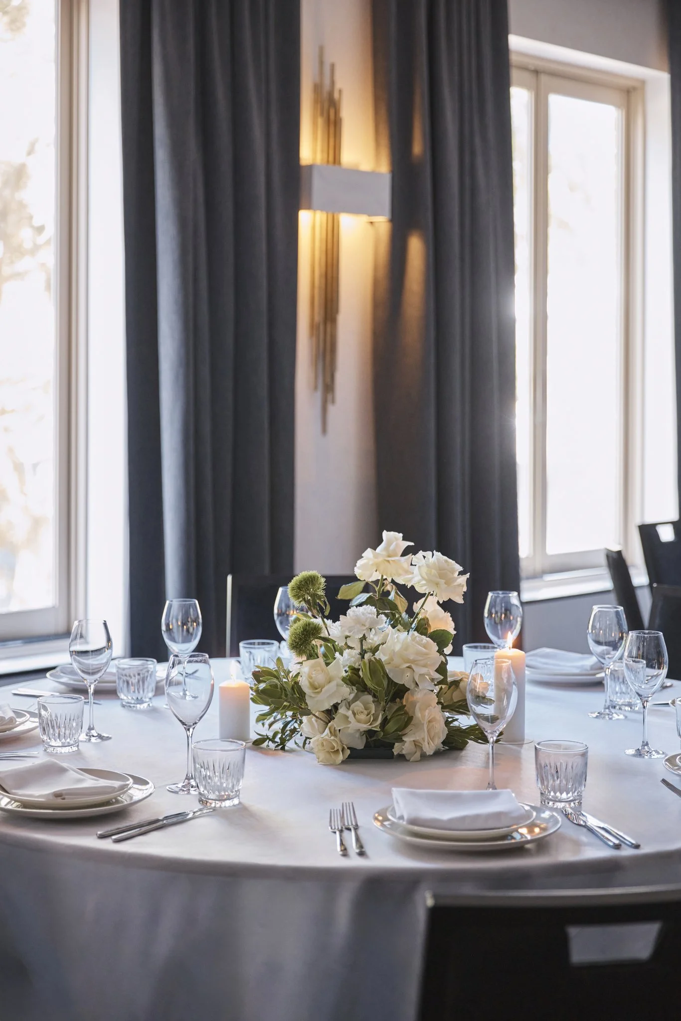 white and green floral arrangement on a white round table