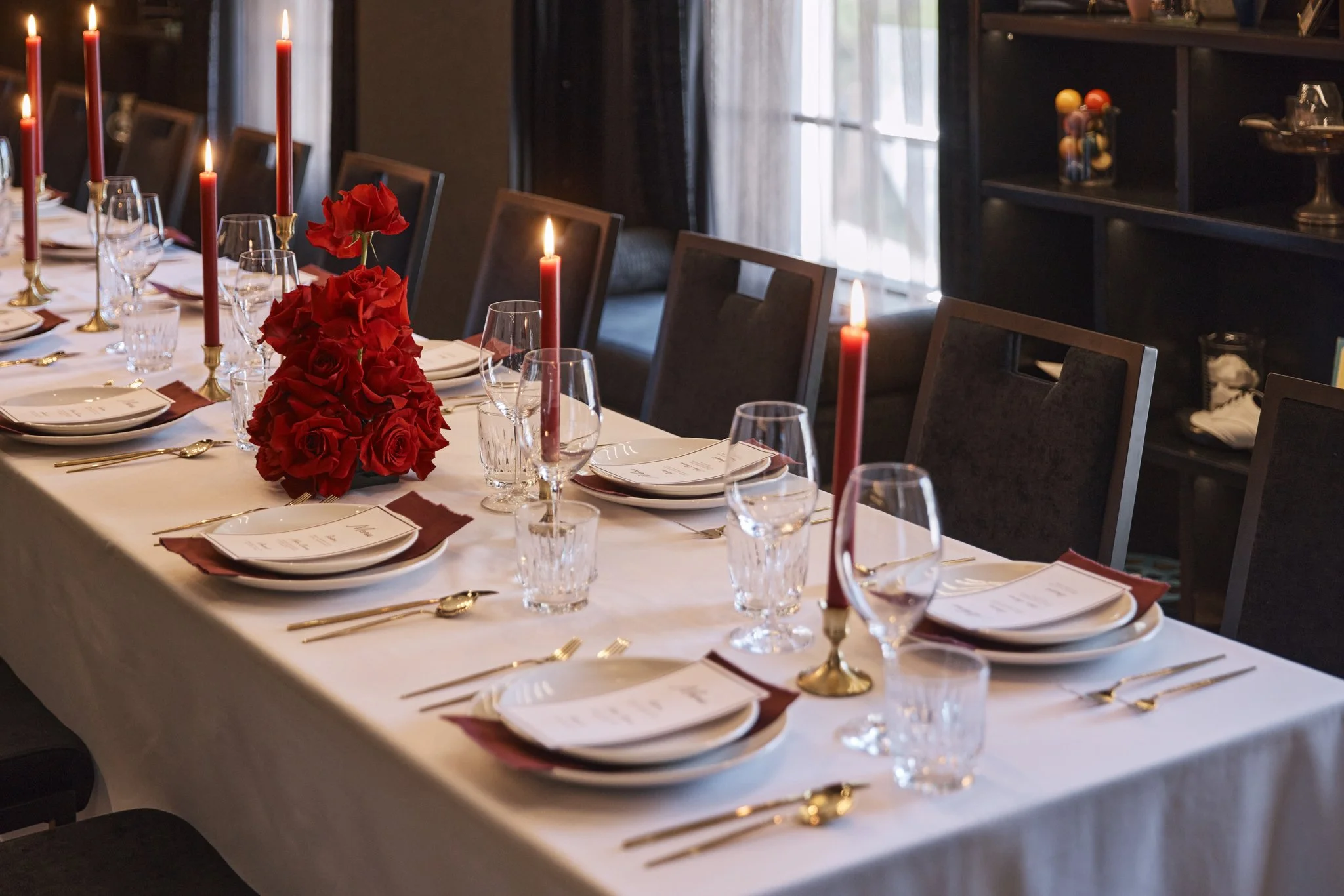 wedding table with red candles and red florals