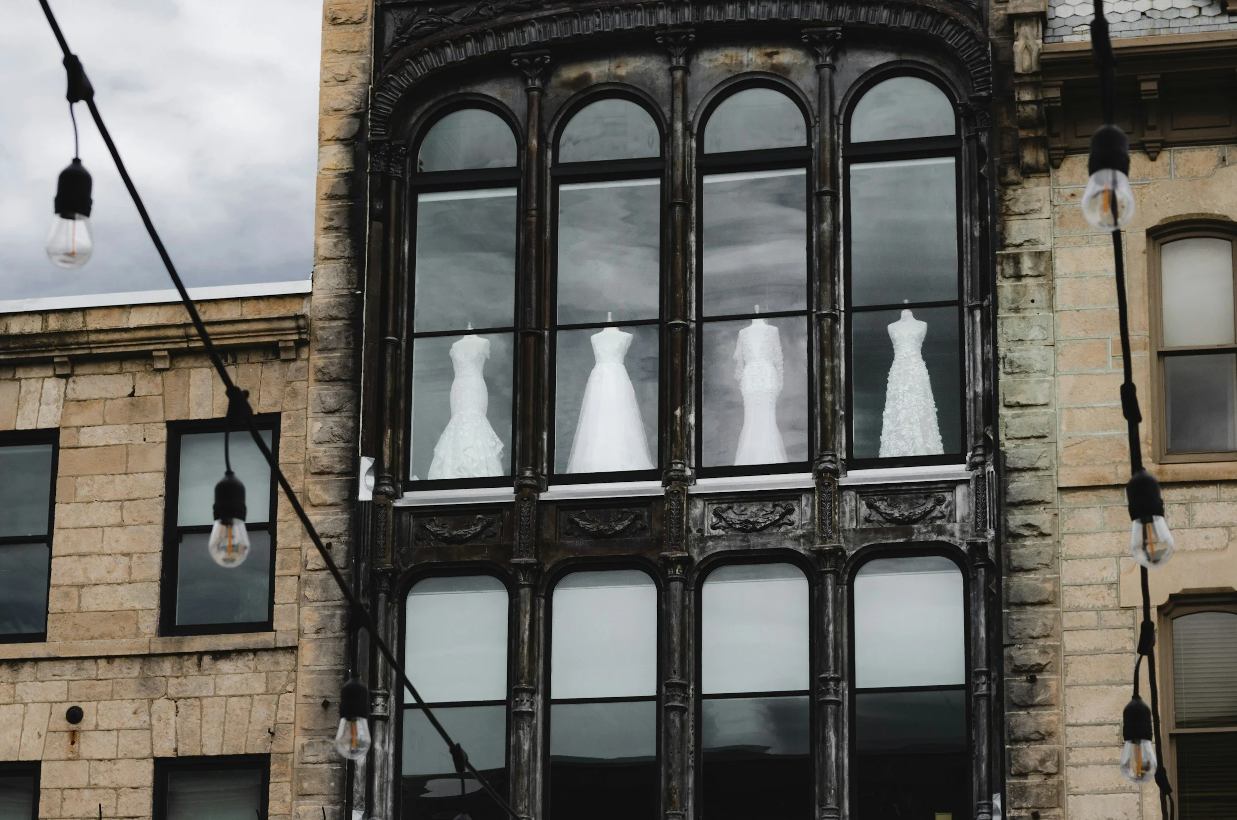 wedding dresses in a 2 storey old building window