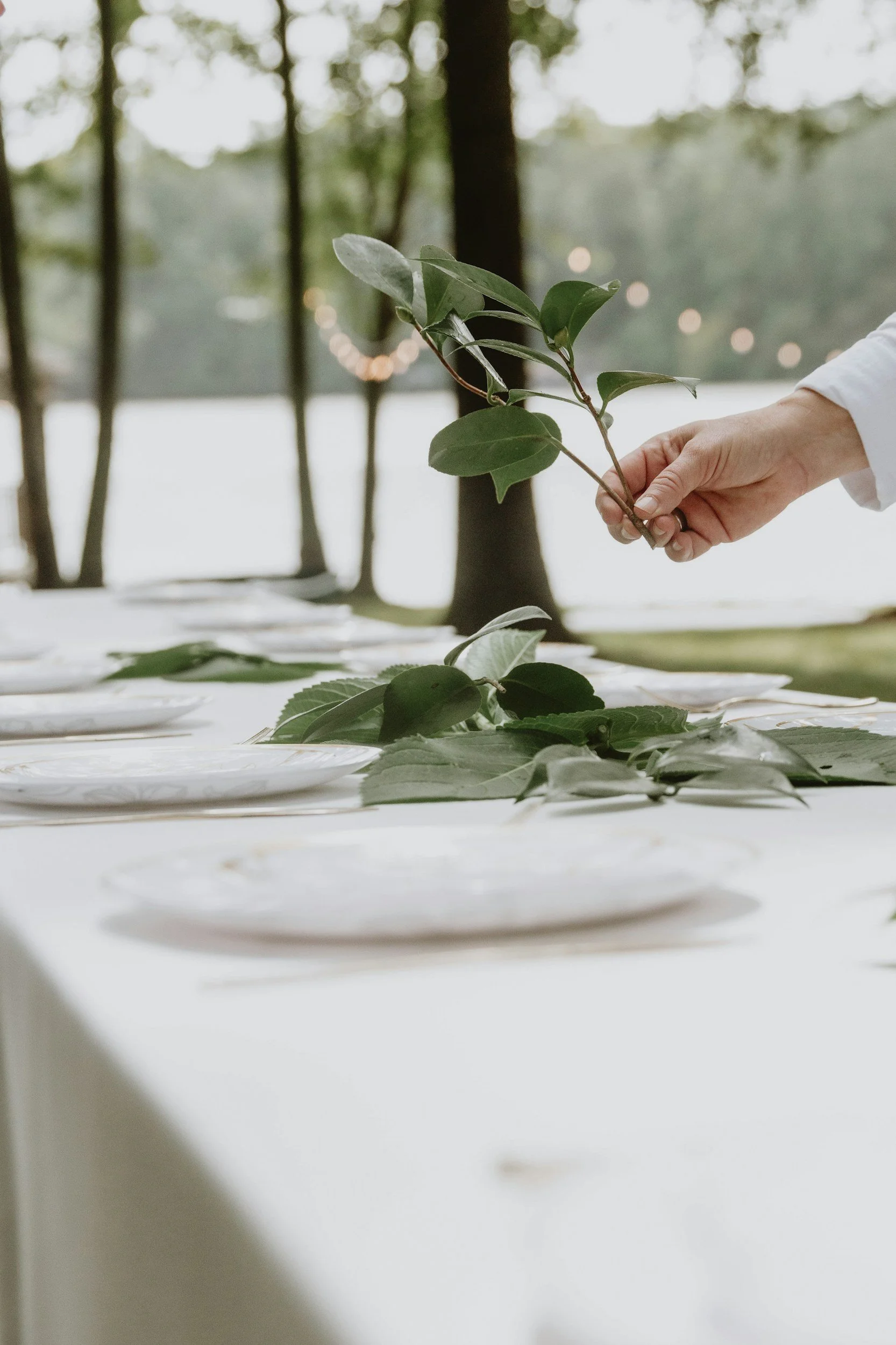 wedding planner placing eucalyptus on the table
