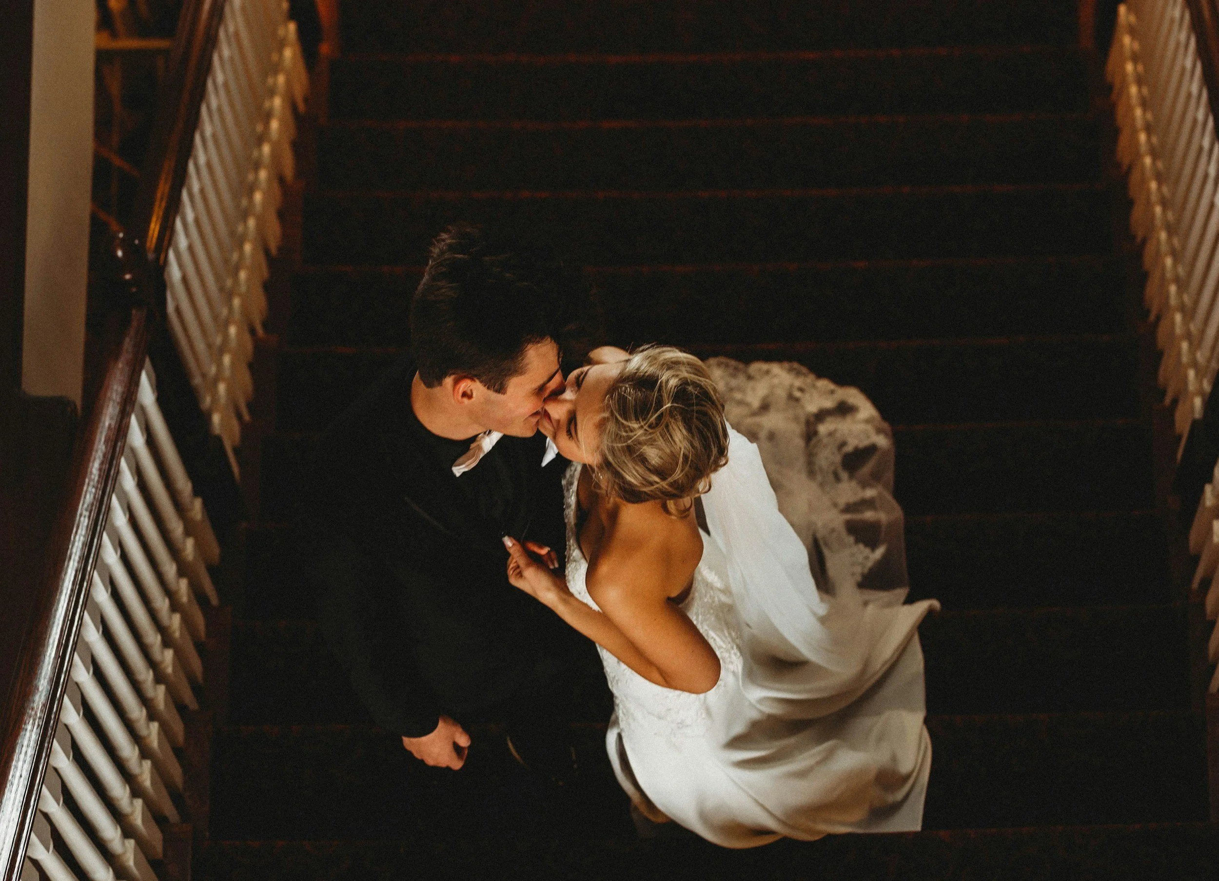 top view of newlyweds kissing on a balcony