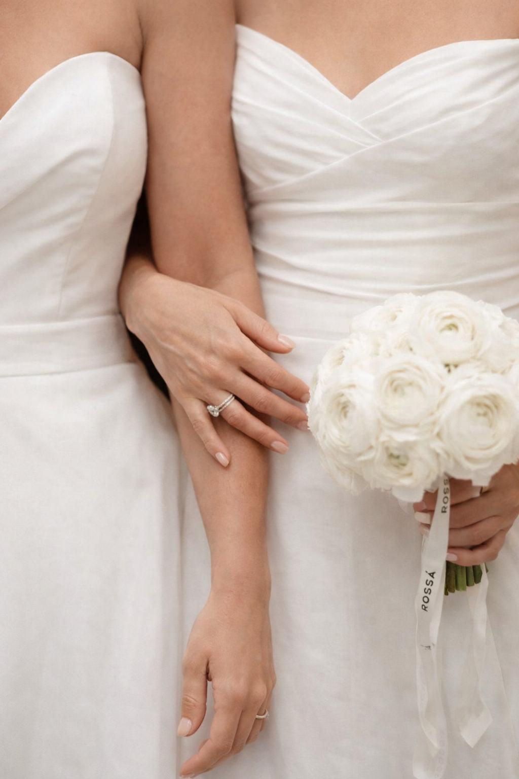 two brides stand side by side