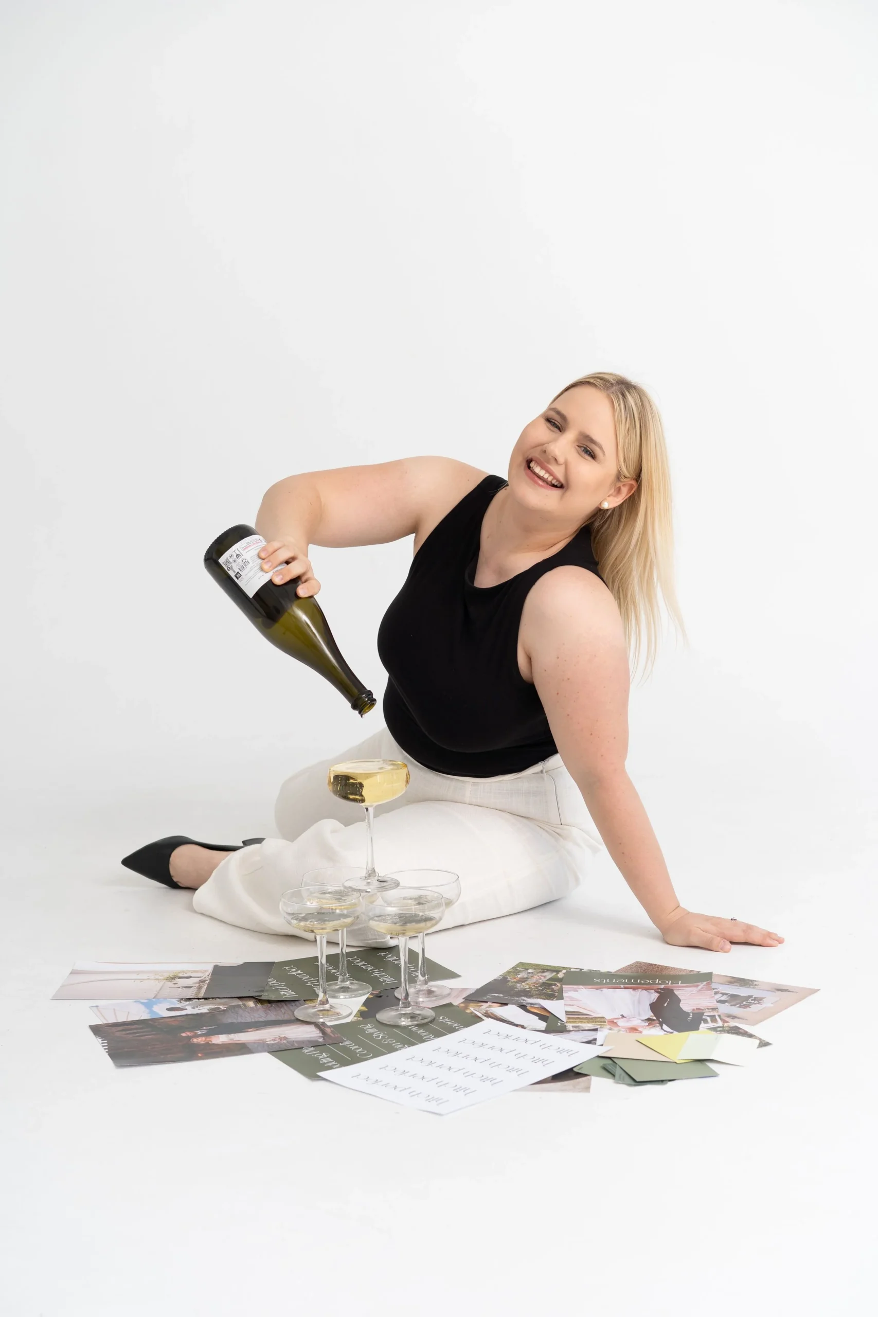 wedding planner pouring champagne into a small champagne tower