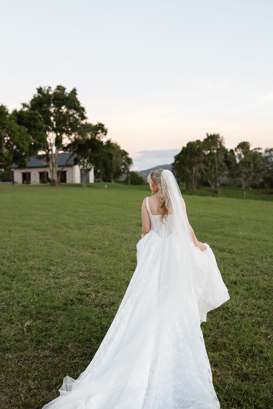 bride walking across an open field